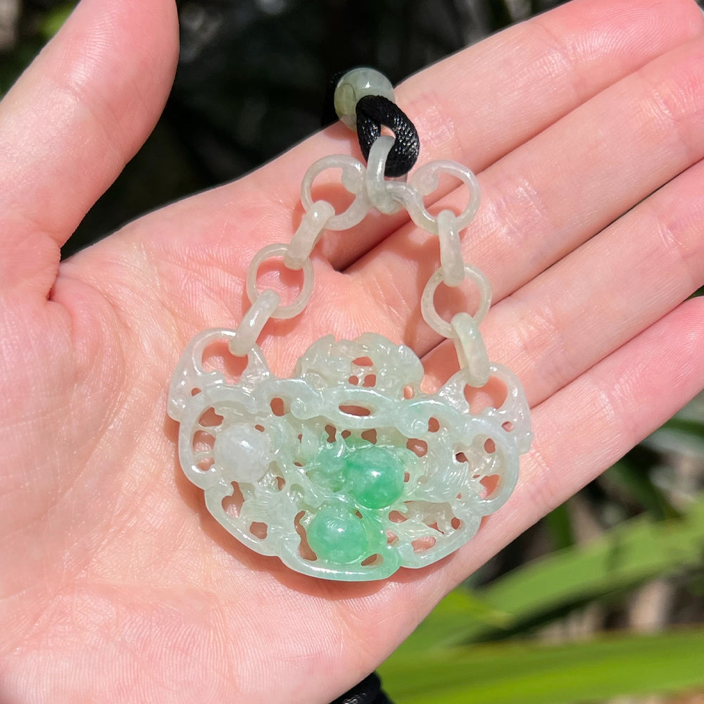 Carved Mottled Green Jade Devils Work Pendant with Birds and Plums